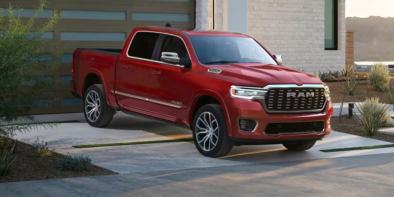 Red RAM 1500 pickup truck parked in a modern driveway.